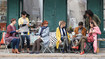 Friends in a café. Some of them are wearing compression stockings.