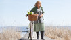  Woman on a walkway close to the beach.